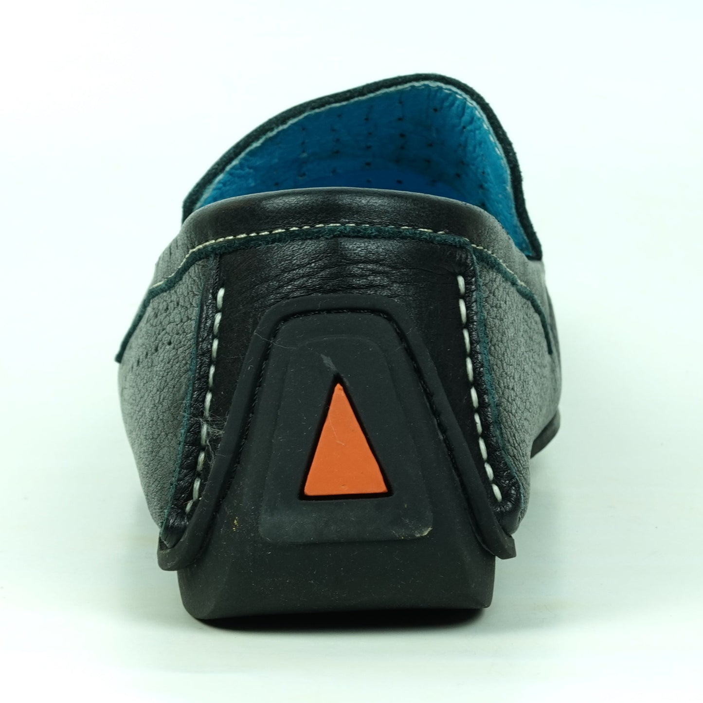 A single black leather loafer shown from the back, featuring white contrast stitching, a blue interior lining, and a small orange triangular accent on the heel.